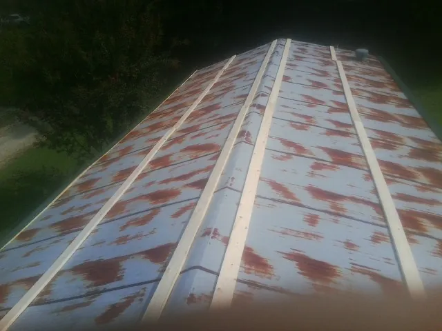 Rusted metal roof panels with new wood purlins before replacement — Storm Damage Roof Repair in Mc Donough by Roofing Brothers
